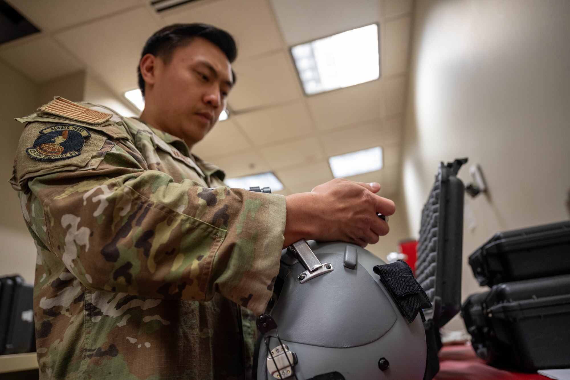 A McConnell Airman mounts night vision goggles to a helmet