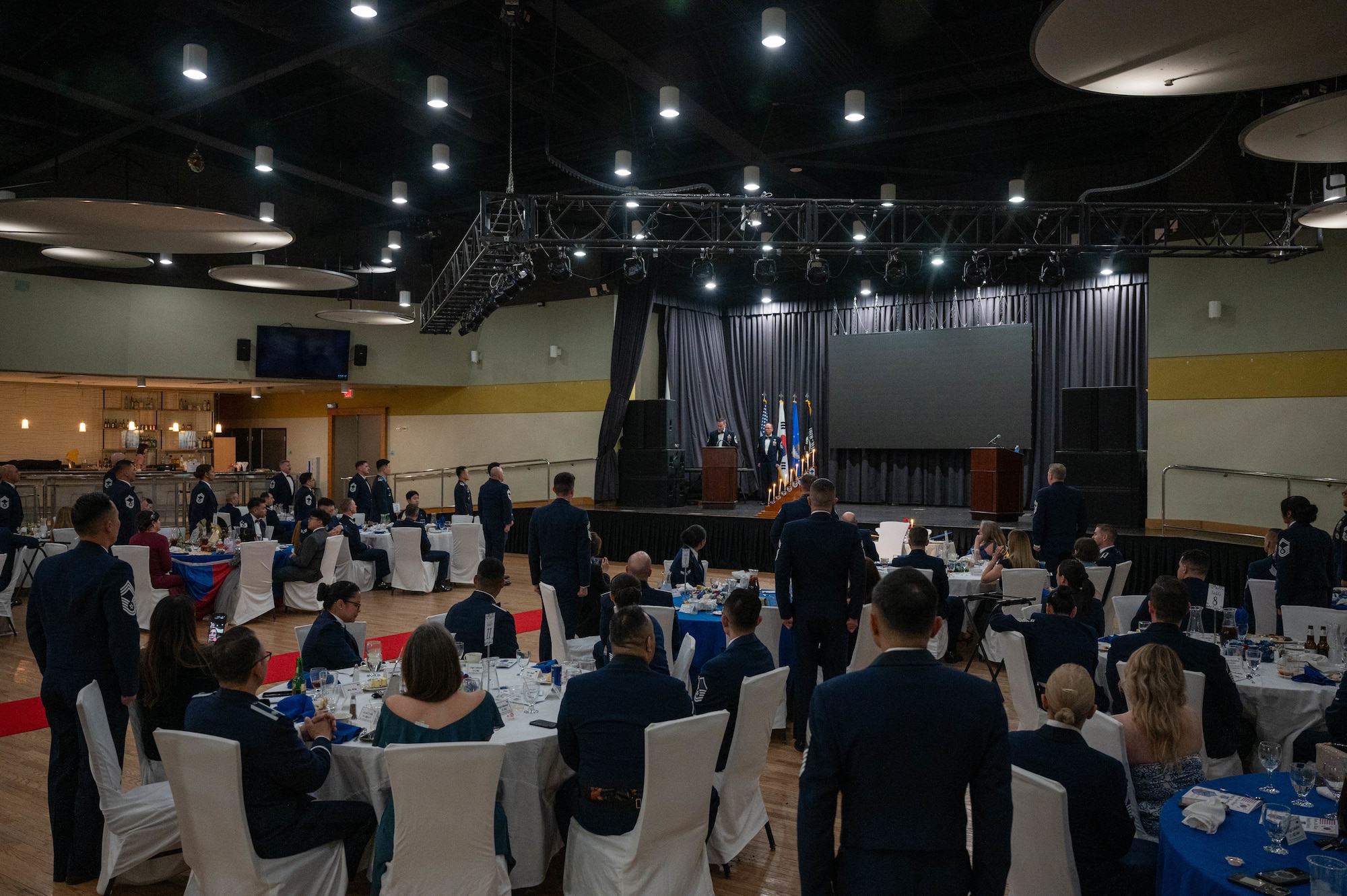 U.S. Air Force chief master sergeants stand and repeat the Chief Master Sergeant oath alongside newly selected chiefs during the 2025 Chief Recognition Ceremony at Osan Air Base, Republic of Korea, April 11, 2025. Those recognized were joined by family, friends and fellow chiefs to honor and recognize their dedication and progression through the ranks. (U.S. Air Force photo by Staff Sgt. Christopher Tam)