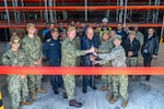 NAVAL SUPPORT ACTIVITY SOUDA BAY, Greece (April 3, 2025) Personnel assigned to Naval Facilities Engineering Systems Command, Navy Region Europe, Africa, Central, Public Works Department; Naval Support Activity (NSA) Souda Bay; and Naval Supply Systems Command Fleet Logistics Center Sigonella, Site Souda Bay, participate in a ribbon cutting ceremony for the P144 Marathi Logistics Support Center at the NATO Marathi Pier Complex, Souda Bay, Greece, on April 3, 2025. NSA Souda Bay is an operational ashore installation that enables and supports U.S., Allied, Coalition, and partner nation forces to preserve security and stability in the European, African, and Central Command areas of responsibility. (U.S. Navy photo by Mass Communication Specialist 2nd Class Andrew Eder)
