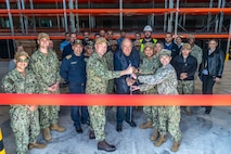 NAVAL SUPPORT ACTIVITY SOUDA BAY, Greece (April 3, 2025) Personnel assigned to Naval Facilities Engineering Systems Command, Navy Region Europe, Africa, Central, Public Works Department; Naval Support Activity (NSA) Souda Bay; and Naval Supply Systems Command Fleet Logistics Center Sigonella, Site Souda Bay, participate in a ribbon cutting ceremony for the P144 Marathi Logistics Support Center at the NATO Marathi Pier Complex, Souda Bay, Greece, on April 3, 2025. NSA Souda Bay is an operational ashore installation that enables and supports U.S., Allied, Coalition, and partner nation forces to preserve security and stability in the European, African, and Central Command areas of responsibility. (U.S. Navy photo by Mass Communication Specialist 2nd Class Andrew Eder)