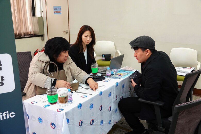 Contracting specialists at an event with local Korean businesses.