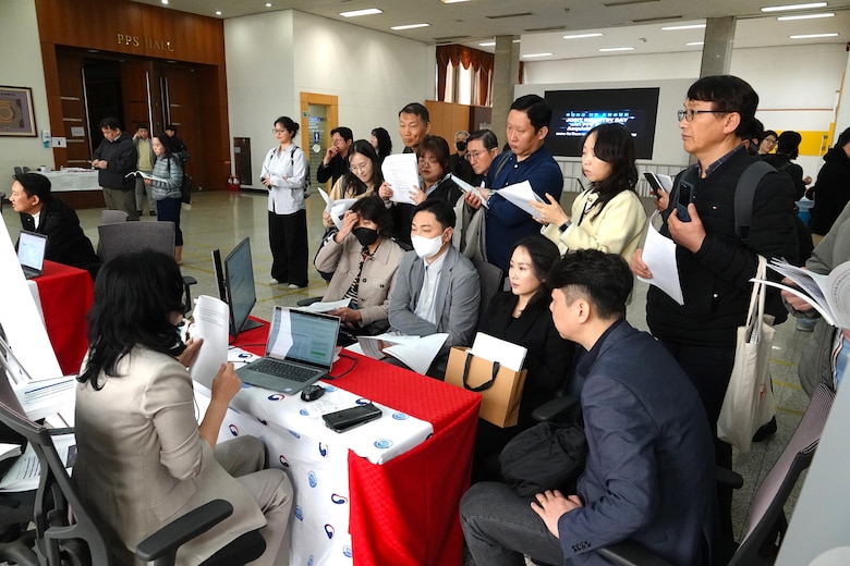 Contracting specialists at an event with local Korean businesses.