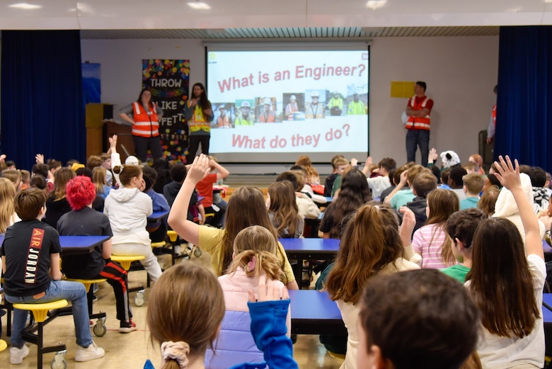 Engineers encourage students during tower building competition.