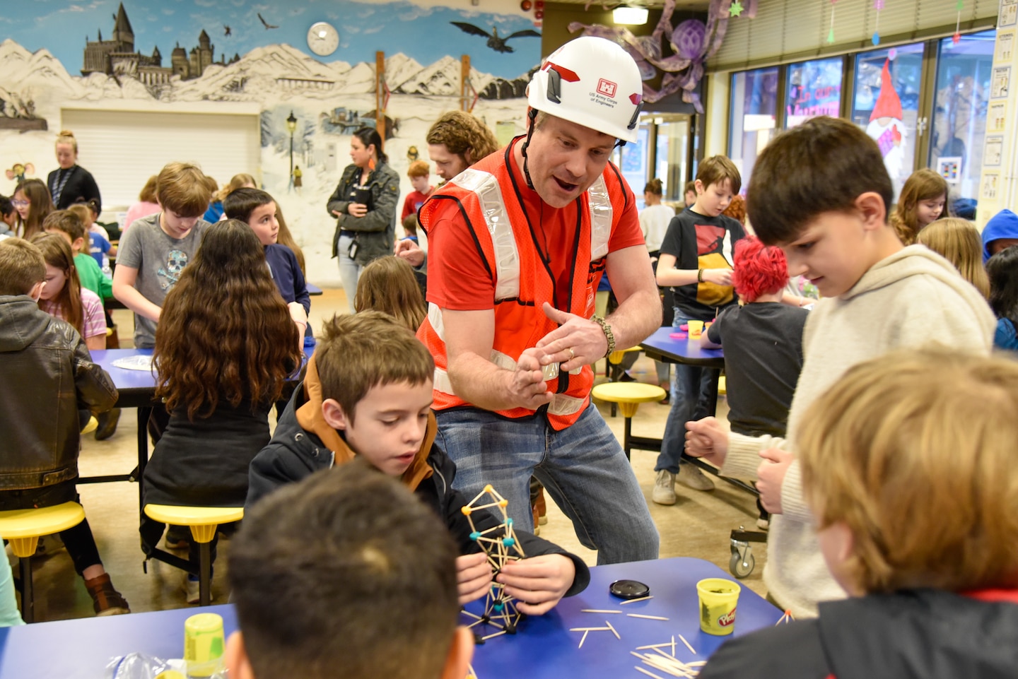 Engineers encourage students during tower building competition.