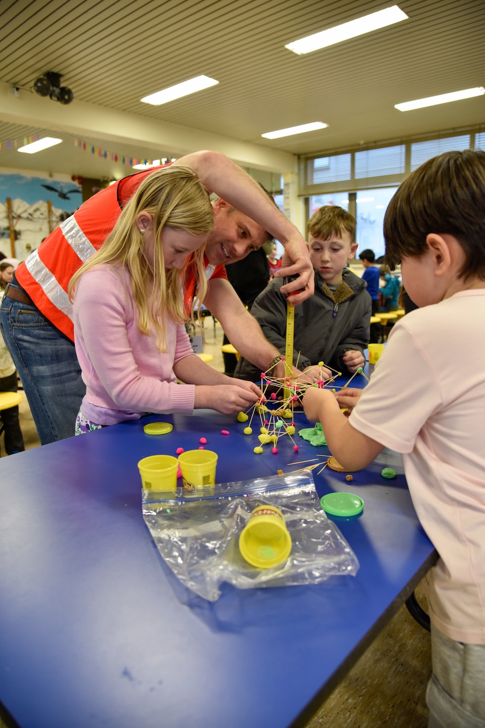 Engineers encourage students during tower building competition.
