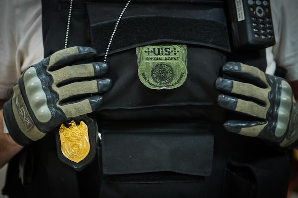 Close up of NCIS badges on tactical chest plate.