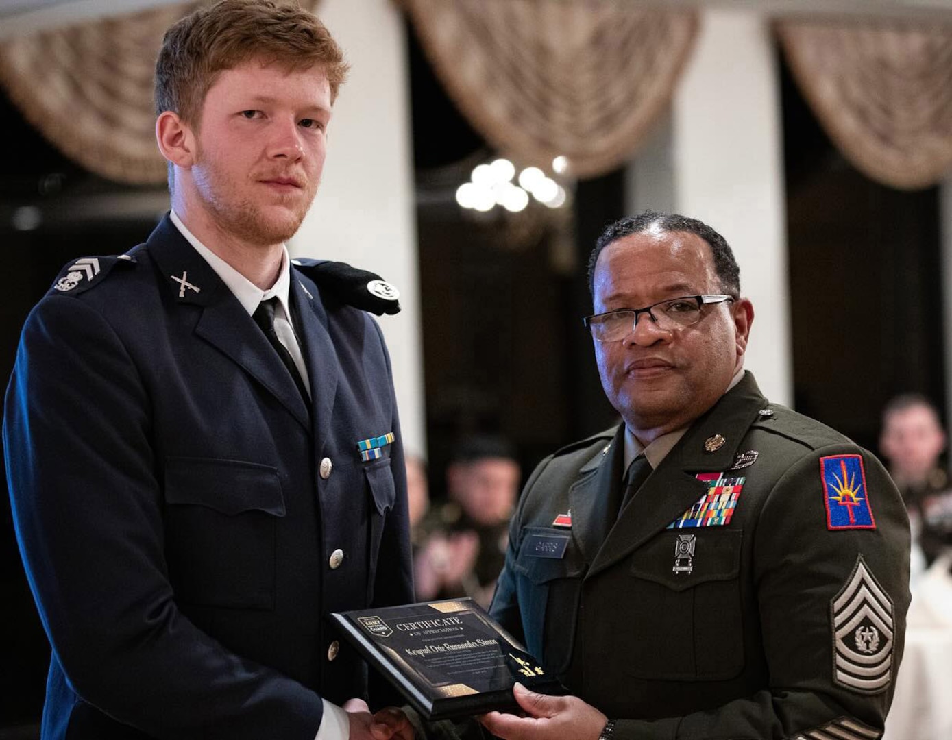 Swedish Army Corporal Simon Drie Runnander, receives an award from New York Army National Guard Command Sgt. Major Edwin Garris, to mark his participation in the New York National Guard Best Warrior Competition, during a dinner at the United States Military Academy at West Point on April 10, 2025.