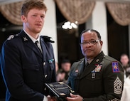 Swedish Army Corporal Simon Drie Runnander, receives an award from New York Army National Guard Command Sgt. Major Edwin Garris, to mark his participation in the New York National Guard Best Warrior Competition, during a dinner at the United States Military Academy at West Point on April 10, 2025.