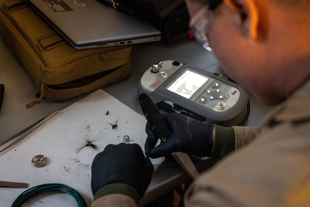 U.S. Marine Corps Staff Sgt. Kevin Allen, a criminal investigator with the 22nd Marine Expeditionary Unit, prepares a sample for testing during Marine Air-Ground Task Force (MAGTF) Interoperability Exercise, on Marine Corps Base Camp Lejeune, North Carolina, Feb. 6, 2025. The raid is one of several training events within MAGTF Interoperability, a course conducted by Expeditionary Operations Training Group. This course is designed to evaluate integrated elements of the 22nd MEU across a variety of full mission profiles in a simulated peer threat environment. (U.S. Marine Corps photo by Sgt. Nathan Mitchell)