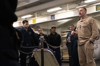 Lt. Cmdr. Corey Sommer, 1st lieutenant aboard the world's largest aircraft carrier, USS Gerald R. Ford (CVN 78), briefs deck department Sailors in the foc'sle, March 17, 2025.
