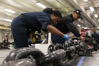 Boatswain's Mate Seaman Apprentice Diamond Cropper (left) and Boatswain's Mate Seaman Recruit Jakari Bobo, both assigned to deck department aboard the world's largest aircraft carrier, USS Gerald R. Ford (CVN 78), paint an anchor chain in the foc'sle, March 17, 2025.