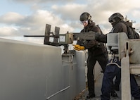 Aviation Ordnanceman 3rd Class John Kierce, left, and Aviation Ordnanceman Airman Elijah Partlow, both assigned to weapons department aboard the world’s largest aircraft carrier, USS Gerald R. Ford (CVN 78), operate an M2 Browning machine gun on the catwalks during a live-fire exercise, March 18, 2025.