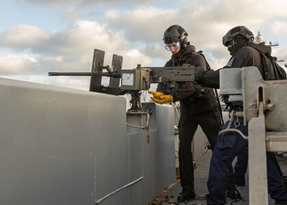 Aviation Ordnanceman 3rd Class John Kierce, left, and Aviation Ordnanceman Airman Elijah Partlow, both assigned to weapons department aboard the world’s largest aircraft carrier, USS Gerald R. Ford (CVN 78), operate an M2 Browning machine gun on the catwalks during a live-fire exercise, March 18, 2025.