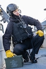 Aviation Ordnanceman 3rd Class John Kierce, assigned to weapons department aboard the world’s largest aircraft carrier, USS Gerald R. Ford (CVN 78), holds an ammunition box on the catwalks during a live-fire exercise, March 18, 2025.