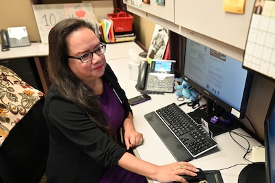 Bleu Garcia, Medical Records Technician Coder at Carl. R. Darnall Army Medical Center, reviews documentation at her workstation. Garcia plays a key role in ensuring accurate medical coding and educating providers and coders alike.