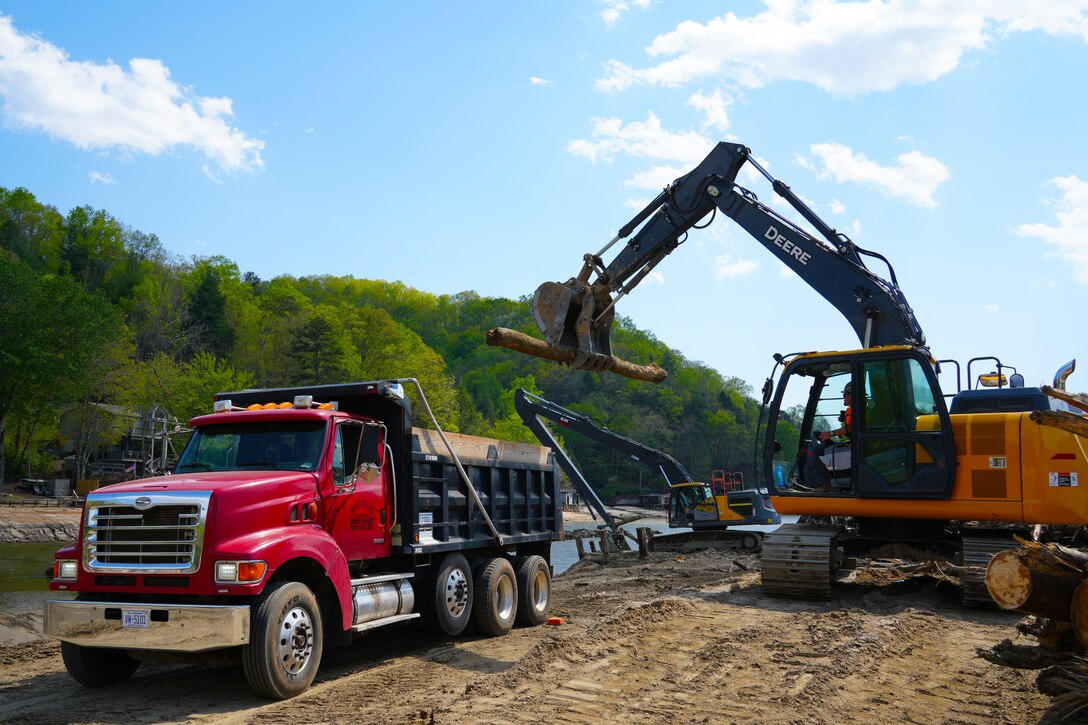 Debris pulled from the bottom of Lake Lure in Rutherford County, North Carolina, is loaded into a dump truck to be hauled to a debris management site, April 14, 2025. Crews continue to work  hard removing hundreds of thousands of submerged debris washed into Lake Lure after Hurricane Helene devastated the region.