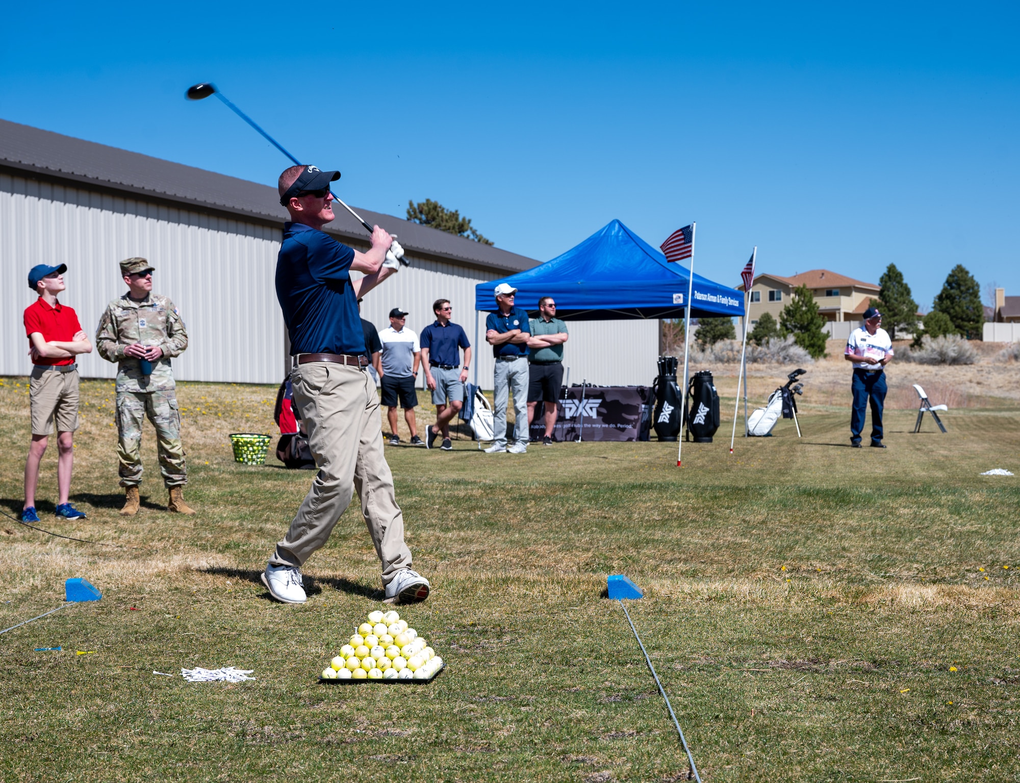 A man swings a golf club.
