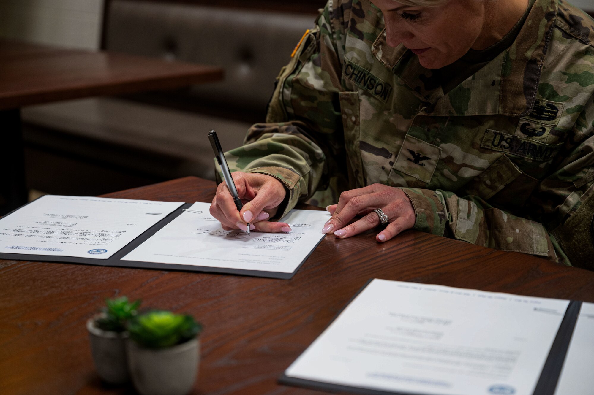 Col. Laura Hutchinson signs an MOU