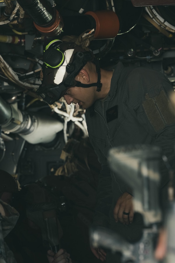 U.S. Marine Corps Cpl. Sean Acosta, a crew chief with Marine Rotational Force – Darwin 25.3 assists Marines in securing seat belts during on-off drills at Royal Australian Air Force Base Darwin, Australia, April 15, 2025. This drill ensures rapid and effective loading and unloading of military personnel aboard a MV-22B osprey. MRF-D 25.3 is part of an annual six-month rotational deployment to enhance interoperability with the Australian Defence Force and Allies and partners and provide a forward-postured crisis response force in the Indo-Pacific. Acosta is a native of Arizona. (U.S. Marine Corps Photo by Sgt. Brian A. Stippey)