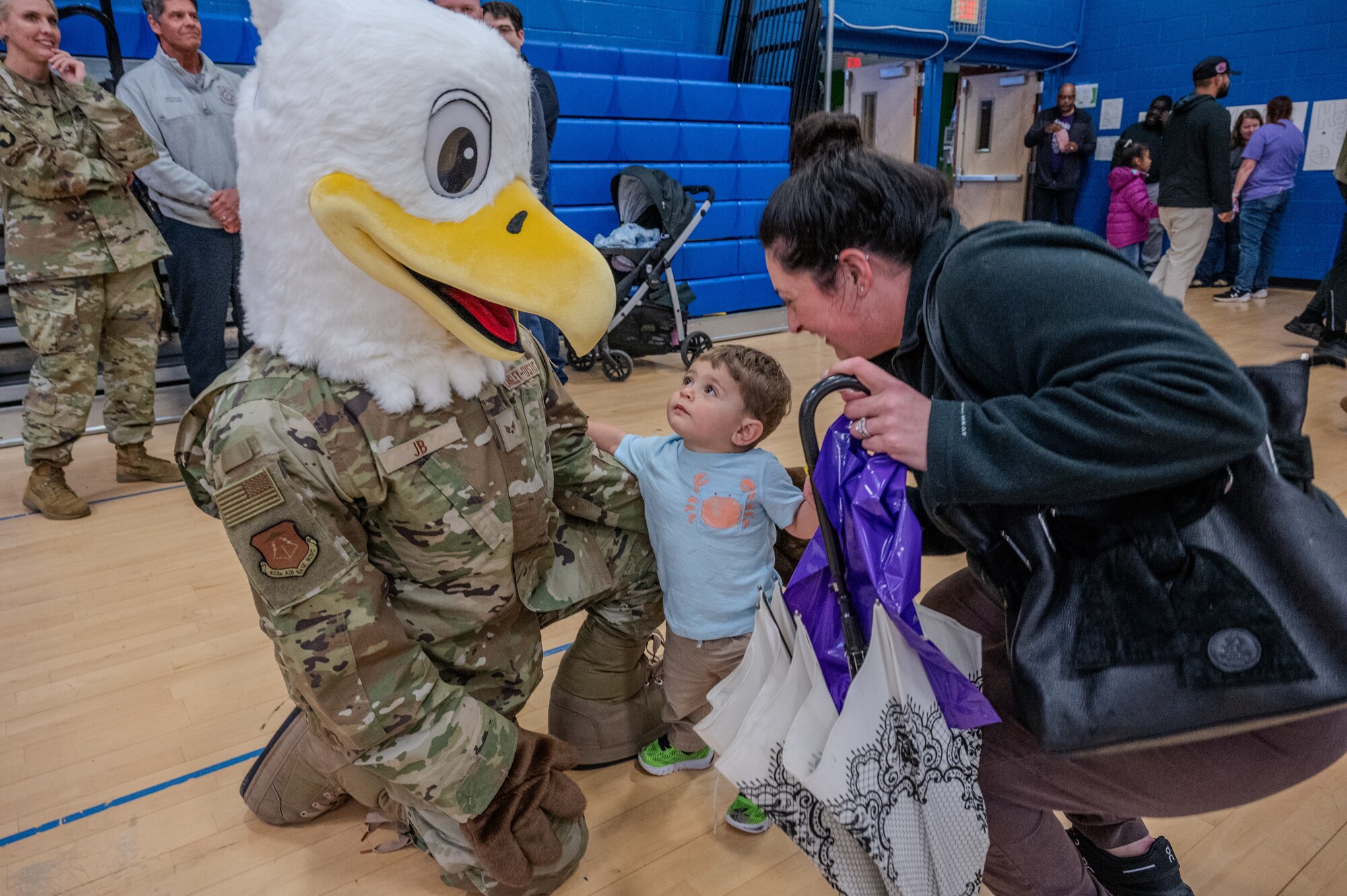 JB the Eagle, Joint Base Langley-Eustis’ mascot interacts with a child and their parent