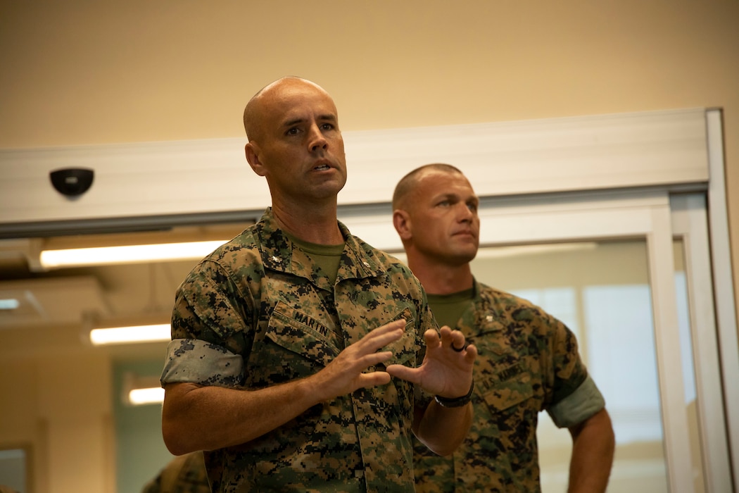 U.S. Marine Corps Lt. Col. Scott Martin, left, commanding officer of Marine Aviation Logistics Squadron (MALS) 24, Marine Aircraft Group (MAG) 24, 1st Marine Aircraft Wing (MAW) and Lt. Col. Benjamin Burgeson, commanding officer of MALS-41, MAG-41, 4th MAW give a brief at the start of exercise Fortified Warrior at Marine Corps Base Hawaii, July 10, 2024. Fortified Warrior integrated MALS-41 and MALS-49, MAG-49, 4th MAW into MALS-24 operations to bolster intermediate level aviation logistics and maintenance capabilities during a period of high operational tempo. (U.S. Marine Corps photo by Cpl. Joseph Abreu)