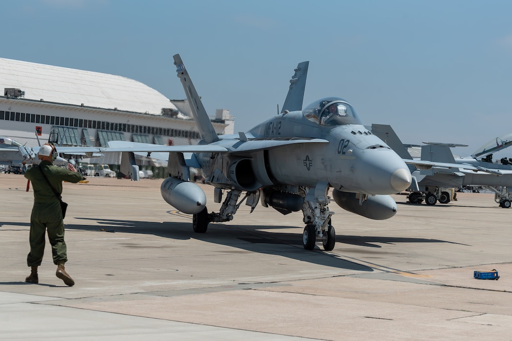U.S. Marine Corps Cpl. Hans Ames, power line mechanic, Marine Fighter Attack Squadron 112 (VMFA), Marine Aircraft Group 41, 4th Marine Aircraft Wing, Marine Forces Reserve, ground guides an F/A-18A Super Hornet at Naval Air Station Joint Reserve Base Fort Worth, TX, June 7, 2024. VMFA-112 is part of the air combat element during Integrated Training Exercise 4-24. ITX provides the Marine Corps Reserve opportunities to conduct force deployment planning, mobilization rehearsals, and increase combat readiness for all elements of the Marine Air-Ground Task Force. (U.S. Marine Corps photo by Staff Sgt. Eric Kilpatrick)