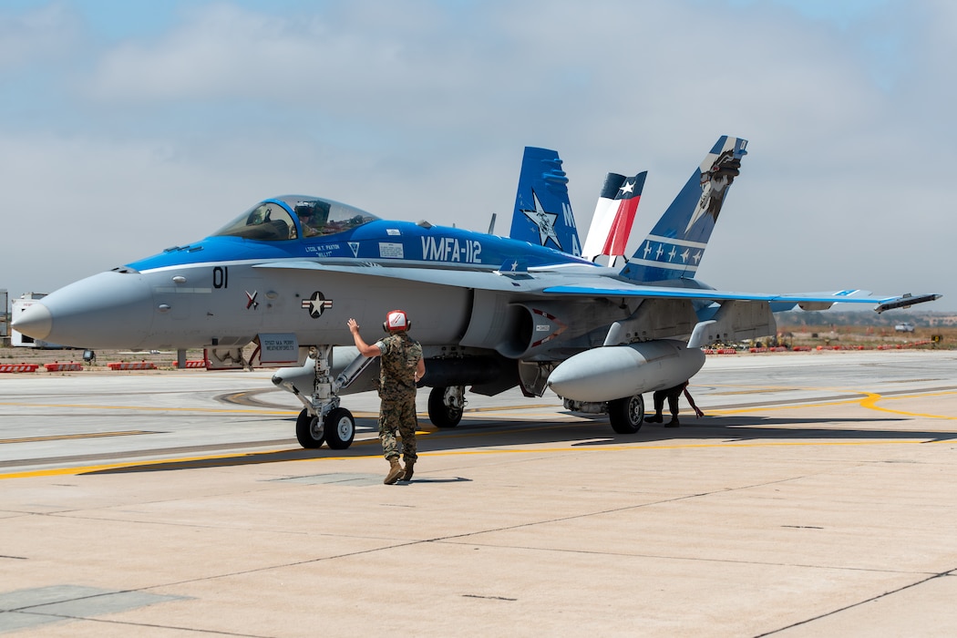 U.S. Marine Corps Lance Cpl. Presley Lewis, aviation ordnance technician, Marine Fighter Attack Squadron 112 (VMFA), Marine Aircraft Group 41, 4th Marine Aircraft Wing, Marine Forces Reserve, ground guides an F/A-18A Super Hornet at Naval Air Station Joint Reserve Base Fort Worth, TX, June 7, 2024. VMFA-112 is part of the air combat element during Integrated Training Exercise 4-24. ITX provides the Marine Corps Reserve opportunities to conduct force deployment planning, mobilization rehearsals, and increase combat readiness for all elements of the Marine Air-Ground Task Force. (U.S. Marine Corps photo by Staff Sgt. Eric Kilpatrick)