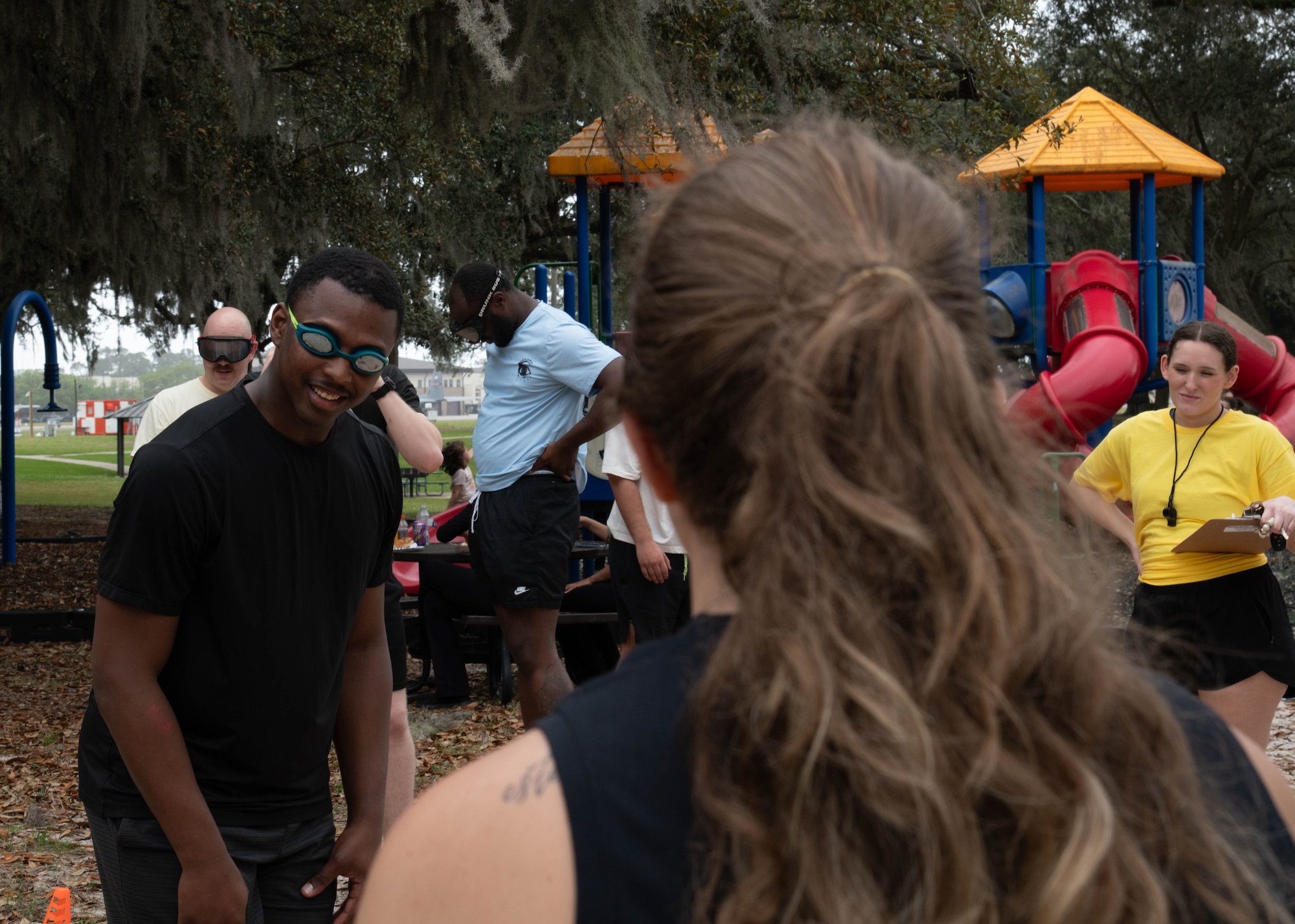 Airmen with goggles on going through obstacle course