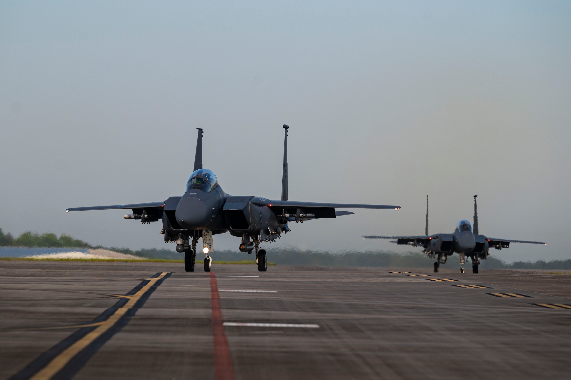 Two U.S. Air Force F-15E Strike Eagles taxi down the flightline during the 2023 William Tell Competition at the Savannah Air National Guard base