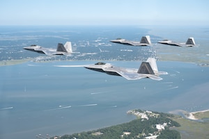 F-22 Raptors from the 27th Fighter Squadron passes over downtown Charleston, South Carolina in a finger-four formation after participating in the William Tell Air-to-Air Competition.