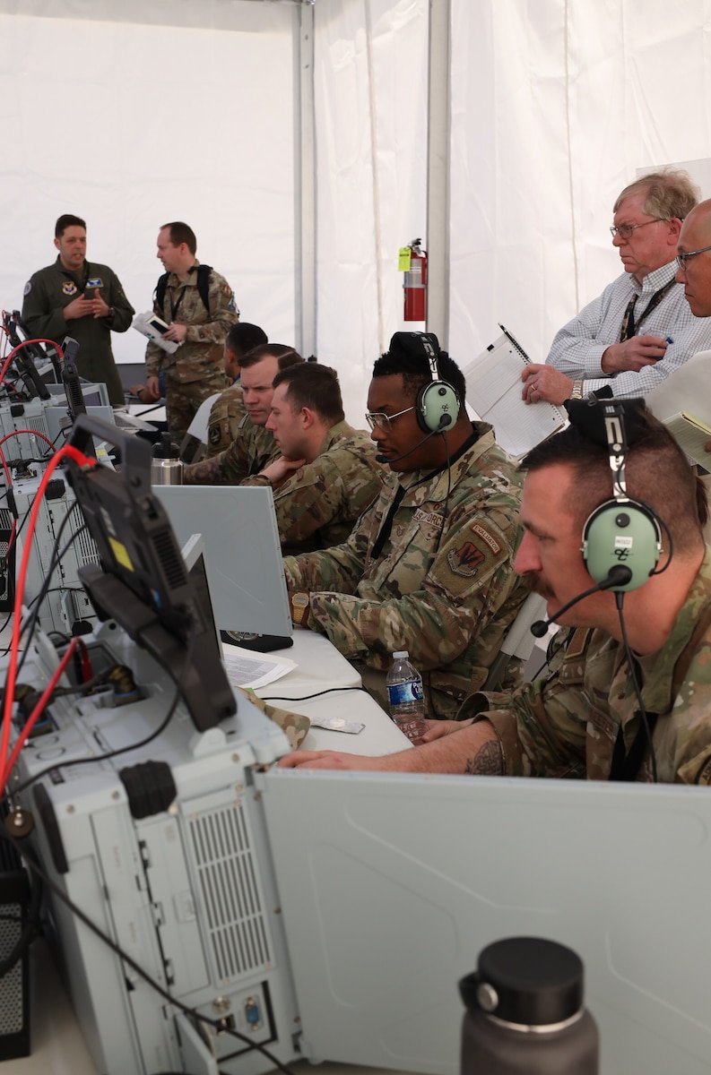 Airmen with the 752 Operations Support Squadron work through their first vulnerably window, or vul, on the Tactical Operations Center – Light during the start of Project Convergence Capstone 5, at the National Training Center, Fort Irwin, California, March 10, 2025. The vul was actively observed by members of the 46th Test Squadron, the 605th Test and Evaluations Squadron, and the Air Force Operational Test and Evaluation Center, which allows for rapid iteration and feedback loops that accelerate the development and refinement of tactics, techniques, and procedures for multi-domain operations. (Official Air Force Photo by Morgan Brown).