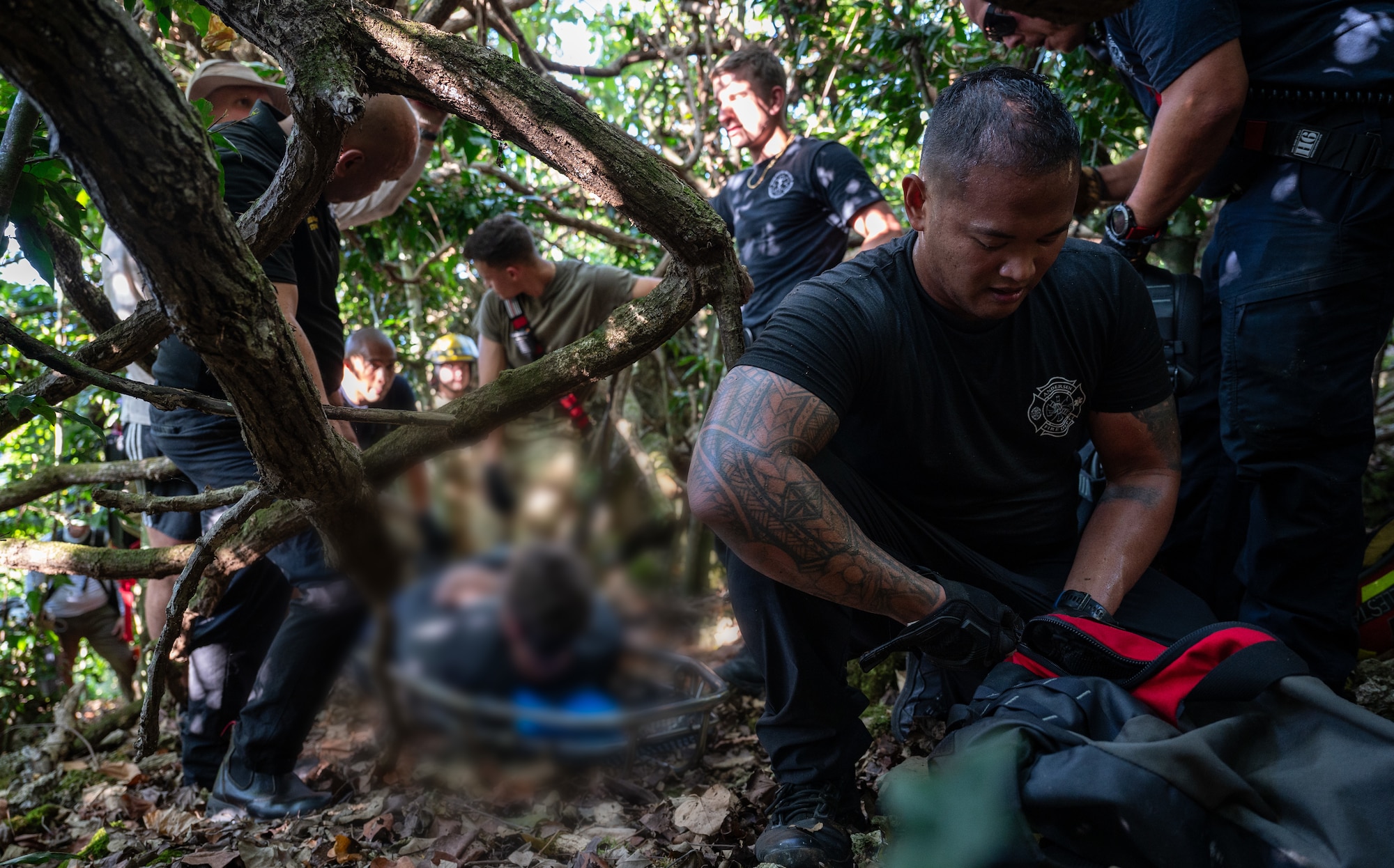 AAndersen Air Force Base Fire Department firefighters and 36th Medical Group paramedics prepare gear to transport an injured hiker on Andersen AFB, Guam, April 11, 2025. Prepared for all types of island scenarios, Andersen firefighters partake in jungle rescue trainings focused on getting their members familiar with high angle and confined space rescues. This experience is invaluable when real-world emergencies, like the one shown, happen. (U.S. Air Force photo by Staff Sgt. Pedro Tenorio)