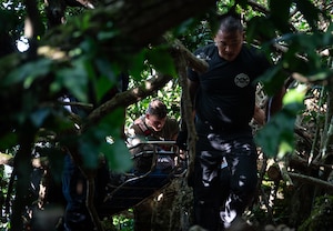 Andersen Air Force Base Fire Department firefighters and 36th Medical Group paramedics transport an injured hiker through the jungle on Andersen AFB, Guam, April 11, 2025. Prepared for all types of island scenarios, Andersen firefighters partake in jungle rescue trainings focused on getting their members familiar with high angle and confined space rescues. This experience is invaluable when real-world emergencies, like the one shown, happen. (U.S. Air Force photo by Staff Sgt. Pedro Tenorio)