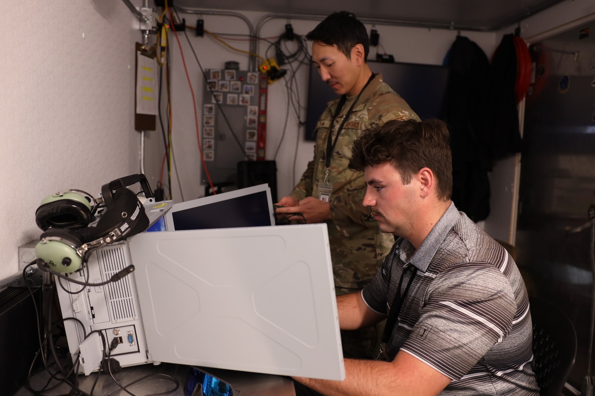 Tech. Sgt. Jay Han and Brendon Jones run a test of their data collection equipment from the Tactical Operations Center – Light during Project Convergence Capstone 5, at the National Training Center, Fort Irwin, California, March 10, 2025. Han, a data link systems tester, and Jones, a test engineer, with the 46th Test Squadron gather data to assess the TOC-L's performance in a simulated operational environment, ensuring its reliability and effectiveness in multi-domain operations. (Official Air Force Photo by Morgan Brown).