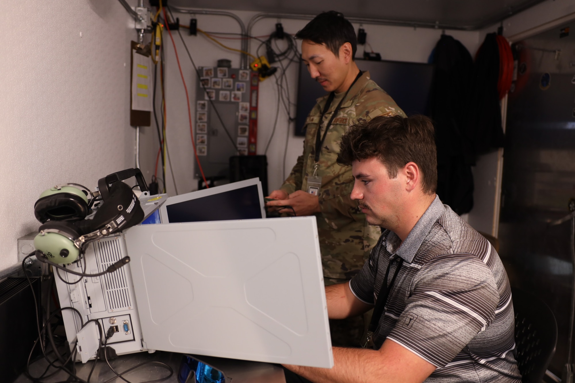 Tech. Sgt. Jay Han and Brendon Jones run a test of their data collection equipment from the Tactical Operations Center – Light during Project Convergence Capstone 5, at the National Training Center, Fort Irwin, California, March 10, 2025. Han, a data link systems tester, and Jones, a test engineer, with the 46th Test Squadron gather data to assess the TOC-L's performance in a simulated operational environment, ensuring its reliability and effectiveness in multi-domain operations. (Official Air Force Photo by Morgan Brown).