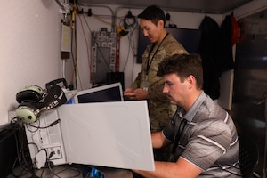 Tech. Sgt. Jay Han and Brendon Jones run a test of their data collection equipment from the Tactical Operations Center – Light during Project Convergence Capstone 5, at the National Training Center, Fort Irwin, California, March 10, 2025. Han, a data link systems tester, and Jones, a test engineer, with the 46th Test Squadron gather data to assess the TOC-L's performance in a simulated operational environment, ensuring its reliability and effectiveness in multi-domain operations. (Official Air Force Photo by Morgan Brown).