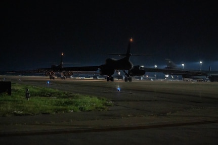 Two B-1B Lancers assigned to the 9th Bomb Squadron taxi on the flightline before takeoff to  support a Bomber Task Force at LOCATION at Dyess Air Force Base, Texas, Apr. 14, 2025 .  BTF deployments like this enhance the readiness and training necessary to respond to any potential crisis or challenge across the globe.