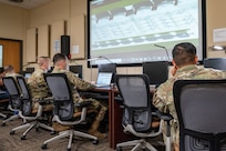 Members of the 318th Training Squadron operate the simulator in the Aircraft Maintenance Officer Course lab. The squadron recently acquired new and upgraded software and equipment that leaders say significantly improves its functionality and accuracy. The acquisition was a result of a collaborative effort between the Inter-American Air Forces Academy and the Air Mobility Command which enabled the Expeditionary Operations School to share its resources. (U.S. Air Force photo by Vanessa R. Adame)