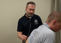 Capt. (Ret.) M. Alaric Franzos, MD, MPH, FACC, FACP, a staff cardiologist at Walter Reed National Military Medical Center, conducts a clinical examination as part of the ERASE program at Joint Base San Antonio-Lackland, Texas, March 22, 2025.