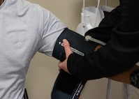 A medical technician takes a basic trainee’s blood pressure during an ERASE cardiac screening at Joint Base San Antonio-Lackland, Texas, March 22, 2025.