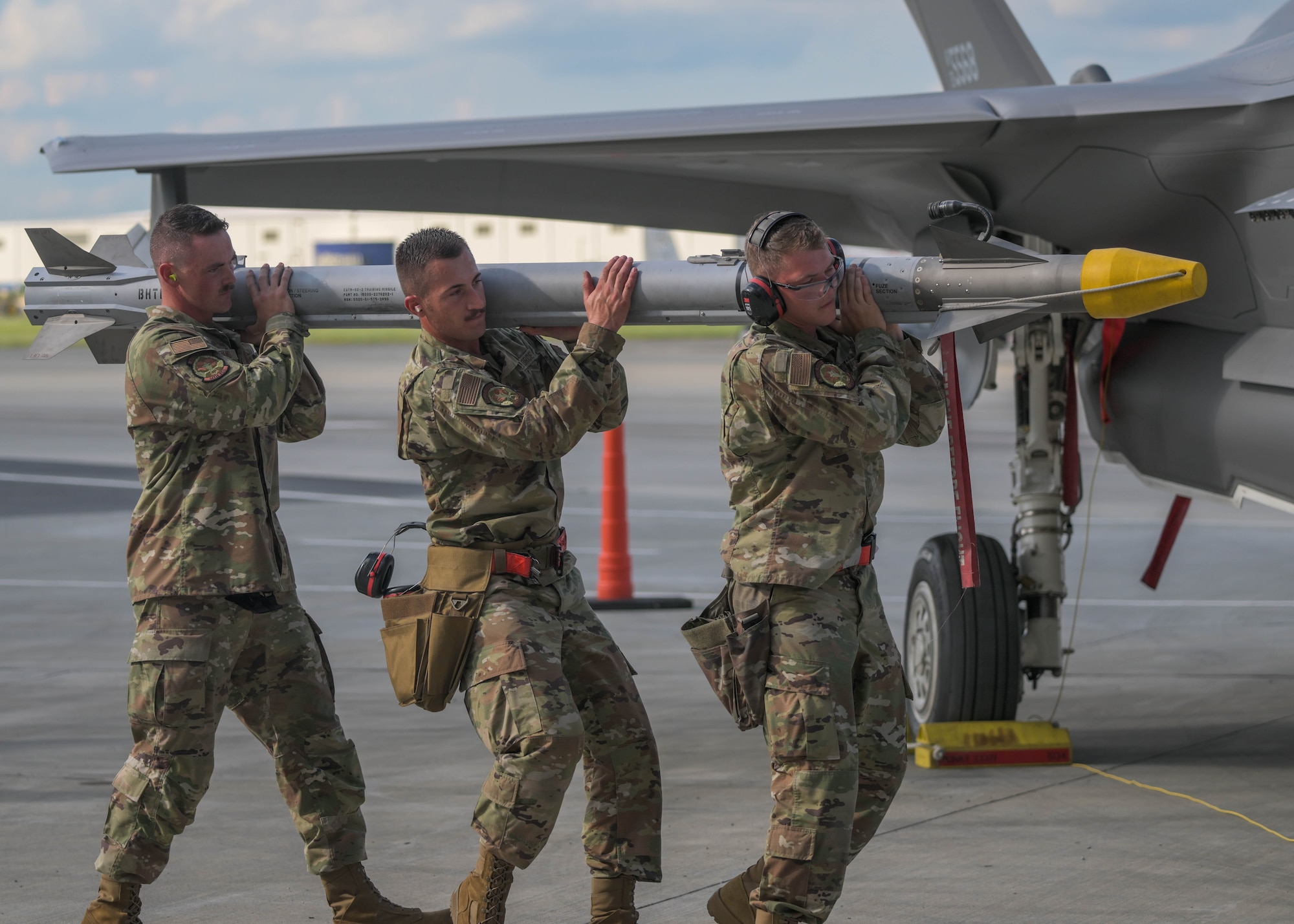 U.S. Air Force Airmen assigned to the 34th Fighter Generation Squadron compete in a weapons load competition