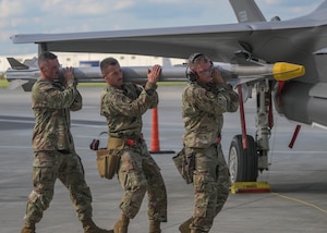 U.S. Air Force Airmen assigned to the 34th Fighter Generation Squadron compete in a weapons load competition