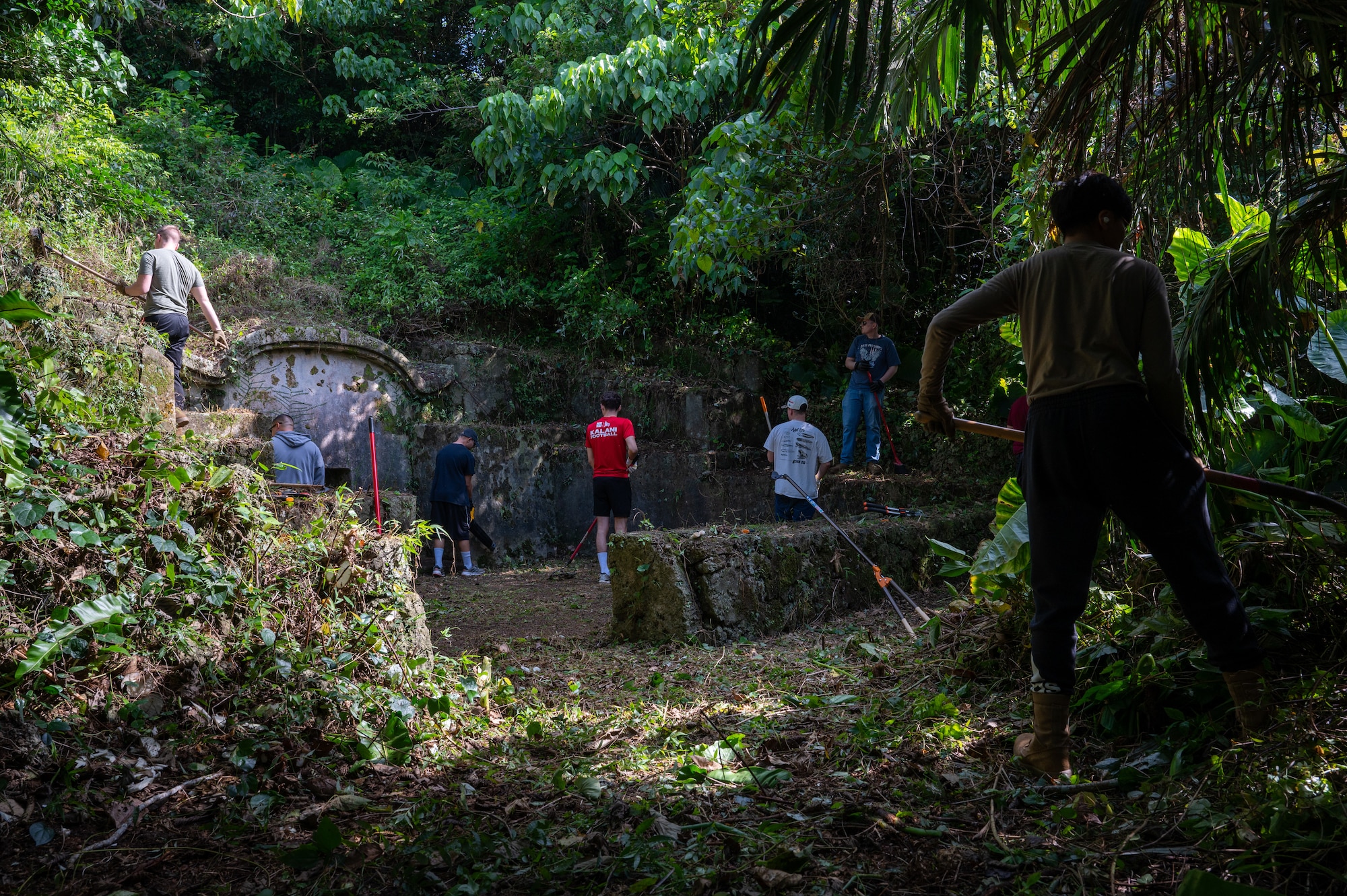 18th MUNS Airmen clear vegetation from a tomb