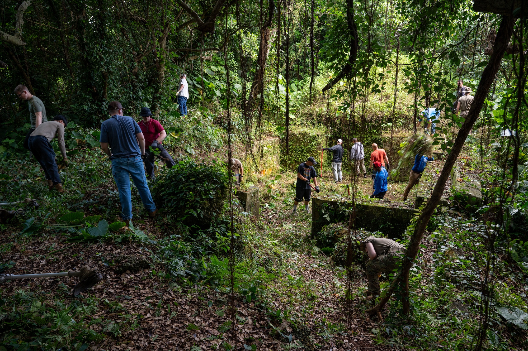 18th MUNS Airmen clearing a tomb of vegetation