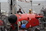 AT SEA (April 10, 2025) Mineman 3rd Class Angel Vazquez and Mineman 2nd Class Daniel Horne conduct mine neutralization vehicle crane operations aboard the Avenger-class mine countermeasures ship USS Warrior (MCM 10) during Korean Spring Exercise (KSE) at sea, April 10, 2025. Korean Spring Exercise increases combined proficiency between the Republic of Korea Navy and the U.S. Navy through the exchange of tactics and techniques, while enhancing common bonds. KSE takes place in U.S. 7th Fleet, the U.S. Navy’s largest forward-deployed numbered fleet, which routinely interacts and operates with allies and partners in preserving a free and open Indo-Pacific region. (U.S. Navy photo by Lt. j.g. Jacob Kinnear.)