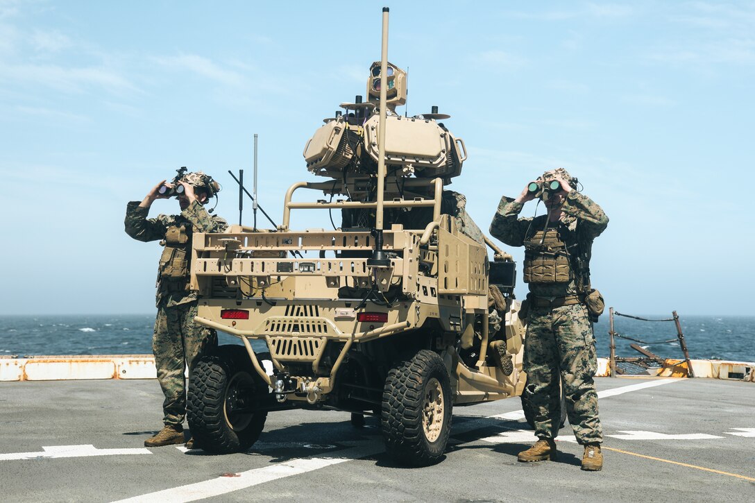 U.S. Marine Corps Cpls. Vernal Emhoolah, left, and Triston Gryniewski, both Low Altitude Air Defense (LAAD) gunners with Marine Medium Tiltrotor Squadron 263 (Reinforced), 22nd Marine Expeditionary Unit, simulate observation of enemy aircraft as part of Amphibious Squadron 8 (PHIBRON 8), 22nd MEU Integration (PMINT) exercise, aboard the San Antonio-class amphibious transport dock ship USS San Antonio (LPD 17), Iwo Jima Amphibious Ready Group (ARG), while underway in the Atlantic Ocean, April 7, 2025. PMINT is the 22nd MEU’s first opportunity in their pre-deployment training program to fully integrate with PHIBRON 8 while at sea, allowing Marines and Sailors to train together as an ARG/MEU team across various functional areas in preparation for their upcoming deployment. (U.S. Marine Corps photo by Cpl. Maurion Moore)