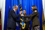 U.S. Army Brig. Gen. Deydre Teyhen passes the Defense Health Agency flag to Dr. David J. Smith, Acting Principal Deputy Assistant Secretary of Defense for Health Affairs and Acting Director of the Defense Health Agency, during the relinquishment of authority ceremony at Walter Reed National Military Medical Center, on April 14, 2025, symbolizing the transfer of leadership. Teyhen served as director of the Defense Health Network National Capital Region for two years. (DOD photo by Ricardo J. Reyes)