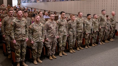 Approximately 15 Soldiers from the Springfield-based 1886th Engineer Facilities Detachment stand at attention during a mobilization ceremony April 15 at Camp Lincoln in Springfield. The Soldiers will deploy in support of Operation Spartan Shield to the U.S. Central Command area of responsibility.