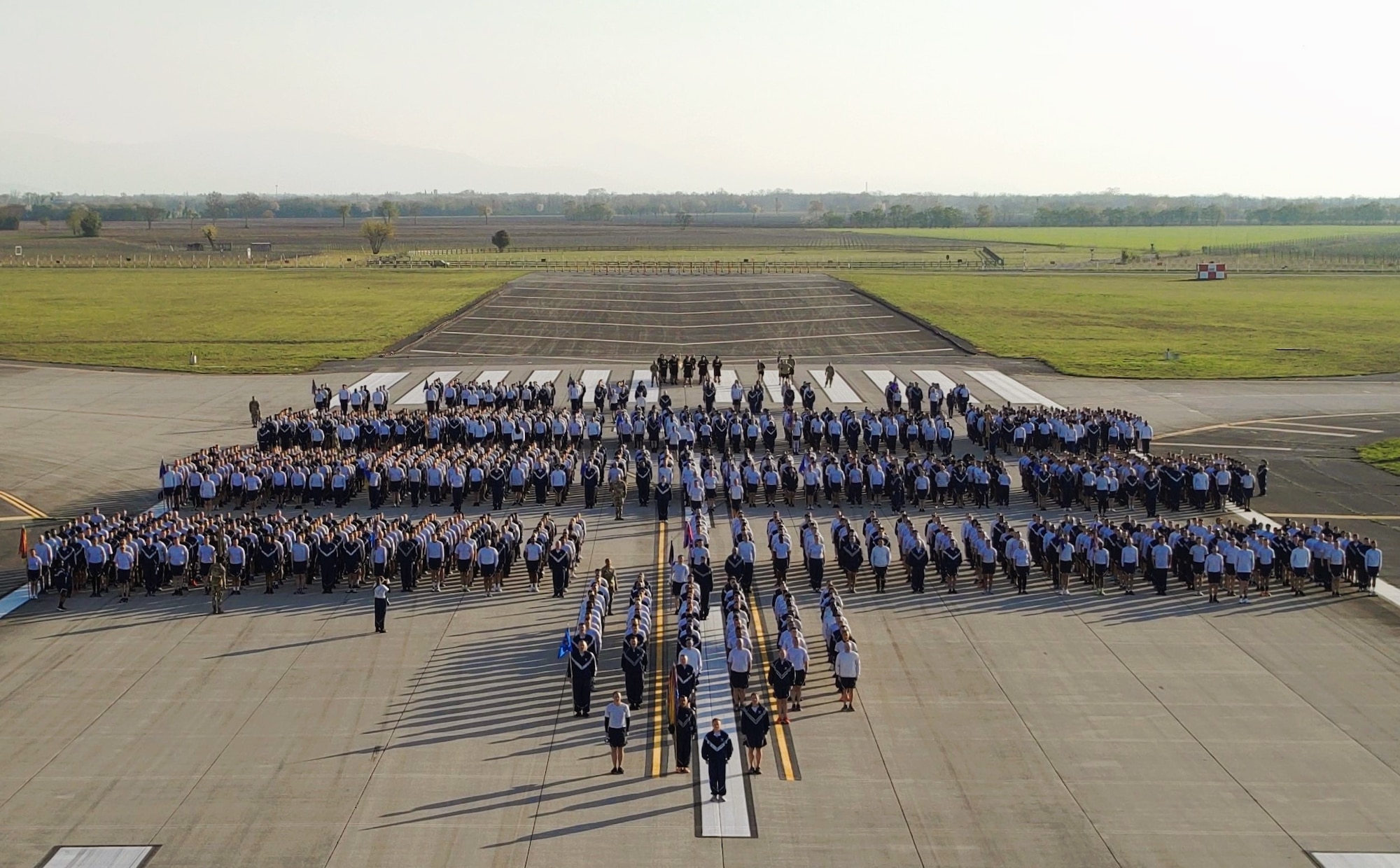 Airmen and soldiers stand in formation.