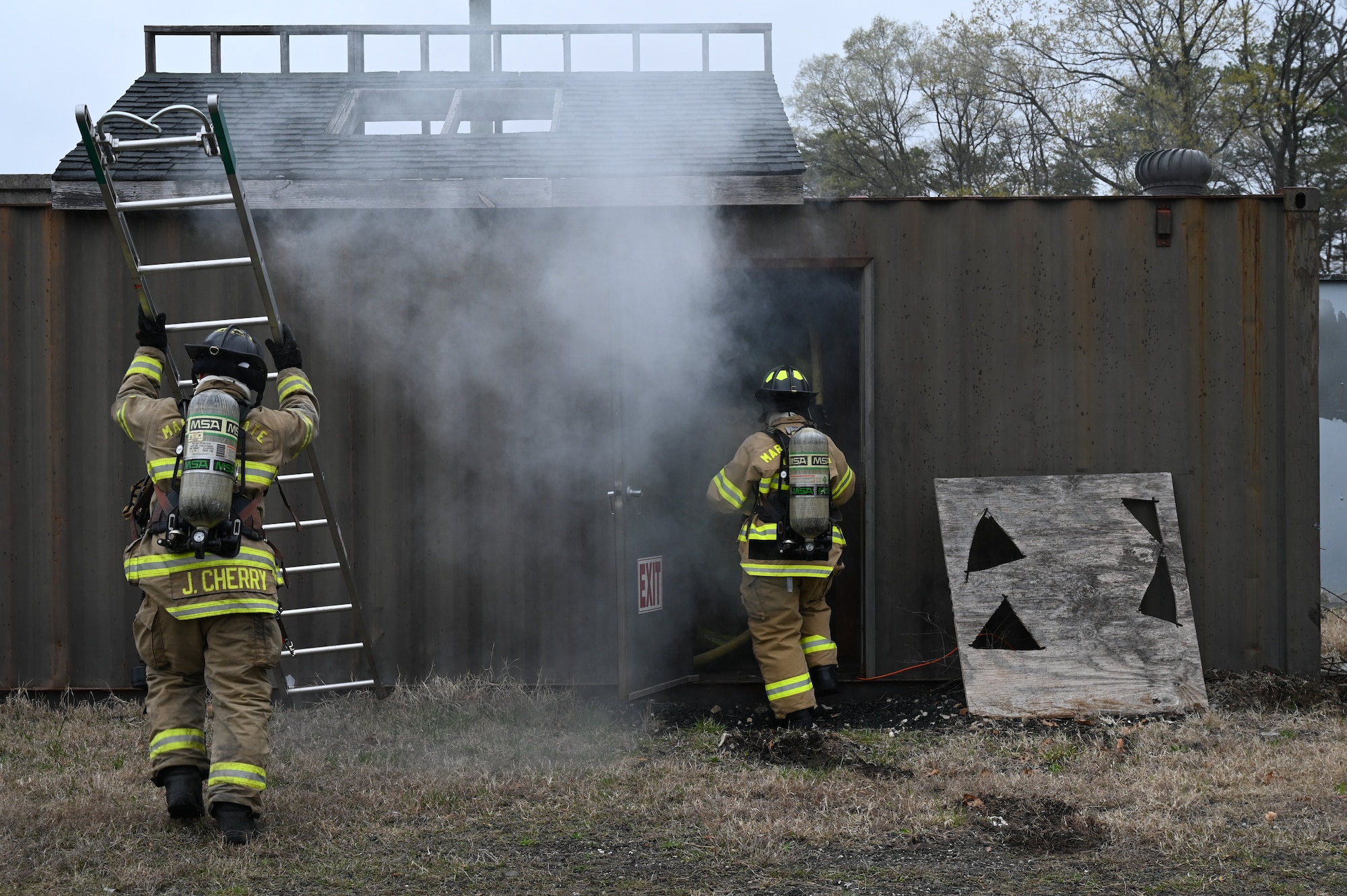 Two members of the 175th Wing fire department clear a simulated burning building at Martin State Air National Guard Base, Middle River, Maryland, April 6, 2025.